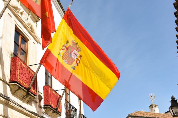 The Spanish flag flies on a building in Madrid